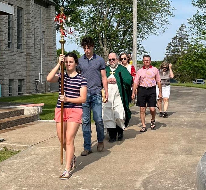 Members and friends of Shrine of St. Patrick Parish in St. Patrick take part in a Memorial Day procession to the parish cemetery after Mass.